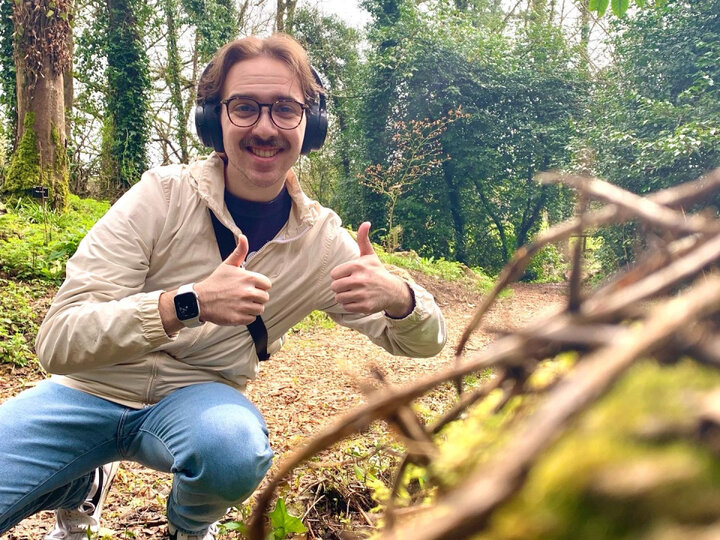 Student in Jungle giving Thumbs Up to Camera